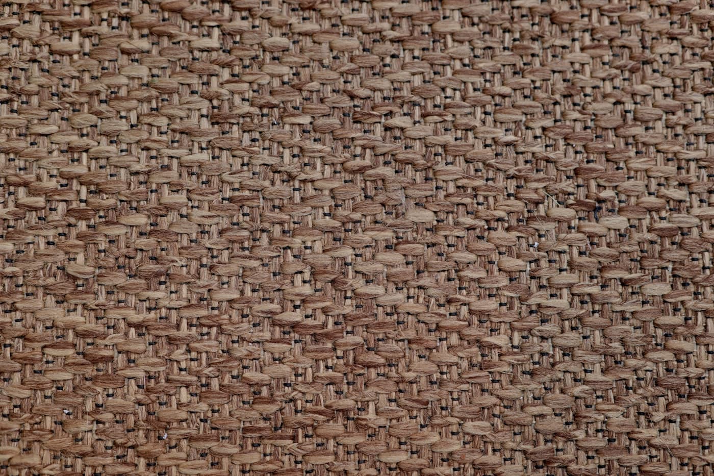 Close view of coarse undyed linen cloth used for wrapping finished work.